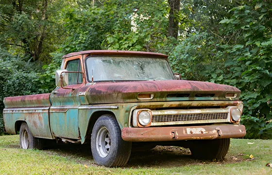 An old truck parked in the grass in Alpharetta, GA, representing opportunities for Cash for Junk Trucks services.