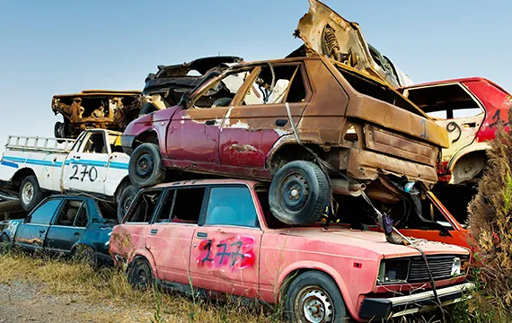 A pile of old cars in a Duluth, GA field, highlighting opportunities for cash for junk trucks in the area.