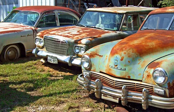 A row of vintage cars parked in a field, symbolizing opportunities to sell your car fast in Atlanta.