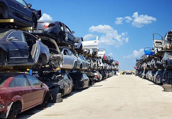 Numerous cars stacked vertically, showcasing the accumulation of junk vehicles for cash offers.