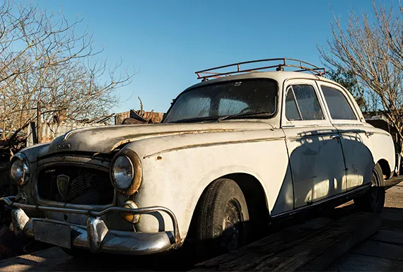 An old car parked on the roadside symbolizes opportunities for fast cash for junk vans.
