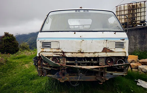 An old van with a damaged front end symbolizes the importance of reliable service and quality in vehicle maintenance.