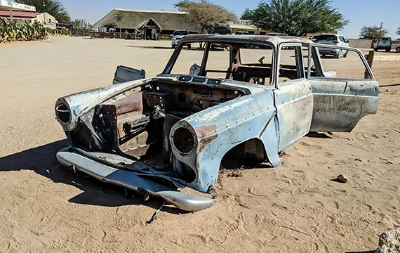 An old car sits in the dirt, symbolizing the potential for cash for junk vans.