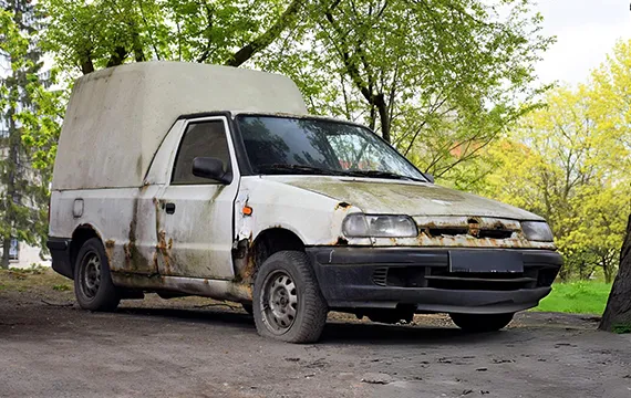 Old white van parked on the roadside for cash for junk vans.